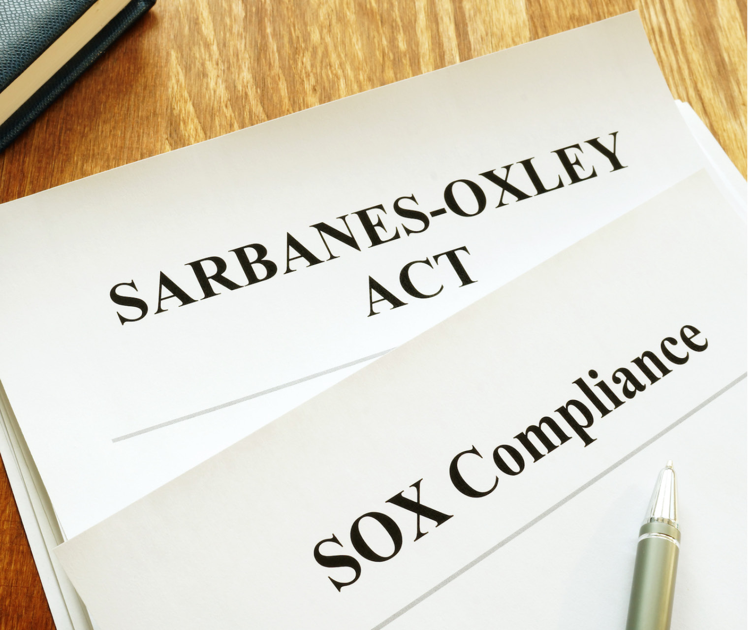 Sarbanes-Oxley Act and Sox Compliance laying on a desk. 