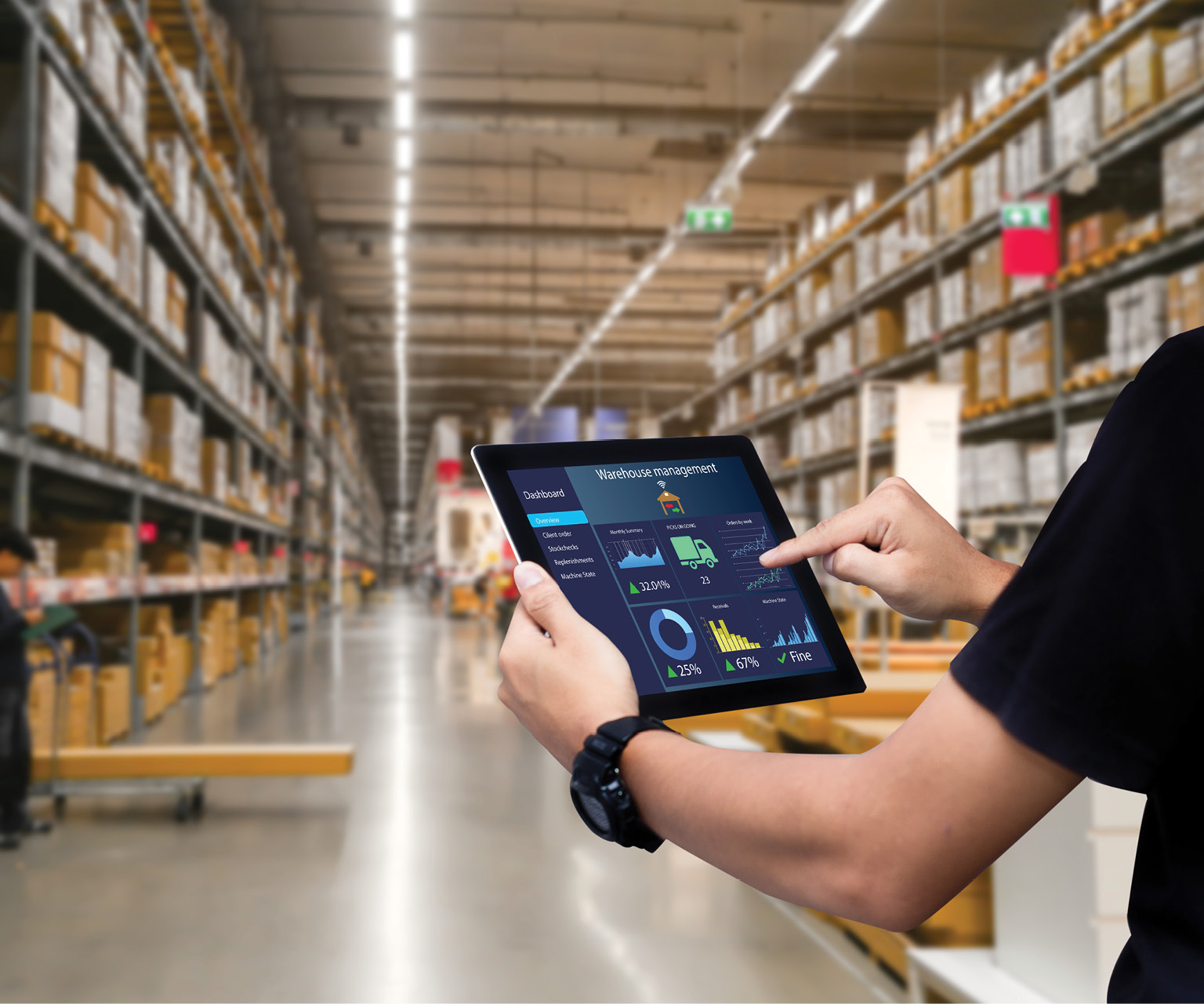 Man holding tablet managing Inventory in a warehouse using Mobile Trunk Stock.